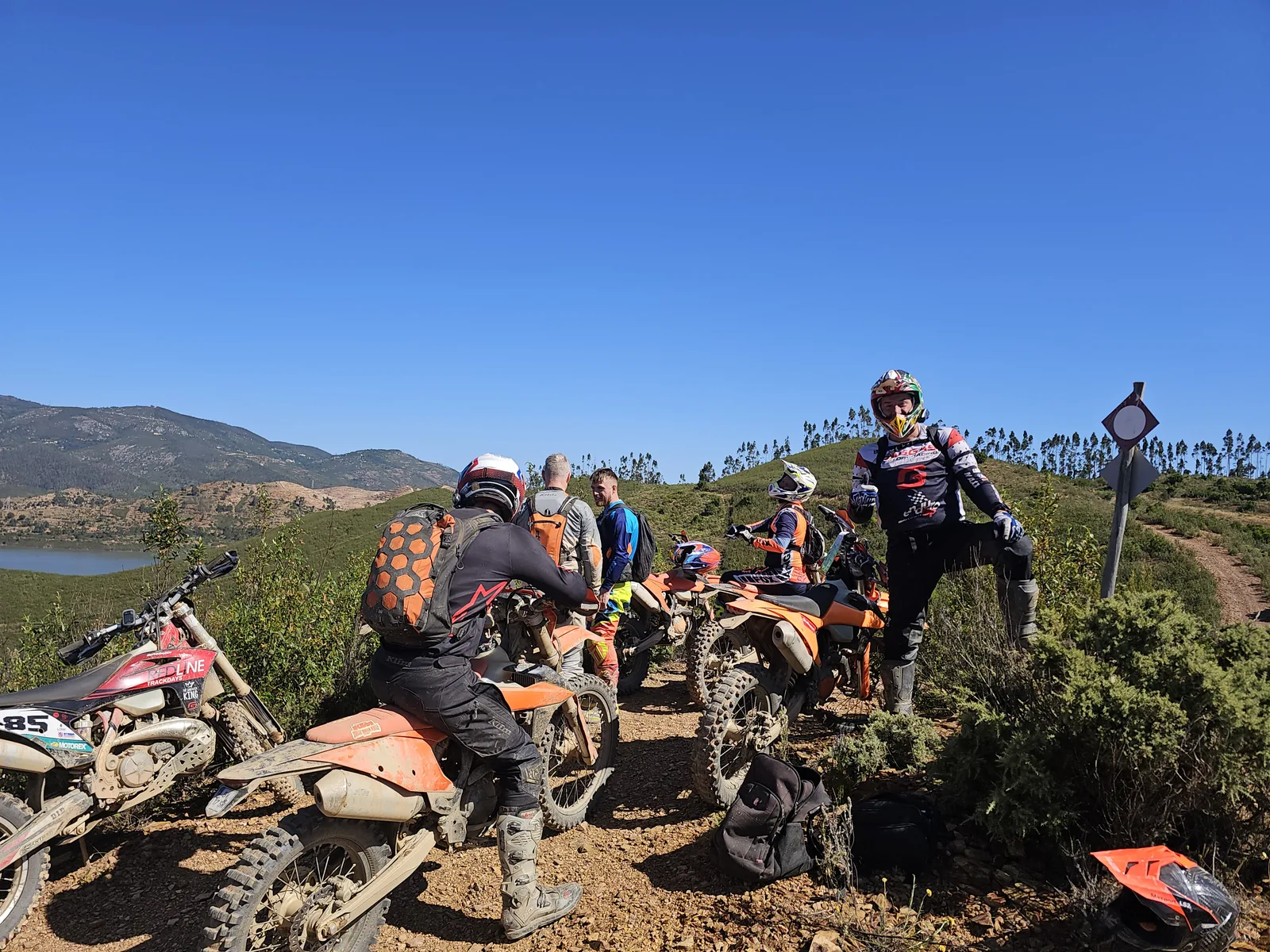 Enduro riders and KTM motorcycles above the Odelouca reservoir in the Silves hinterland.