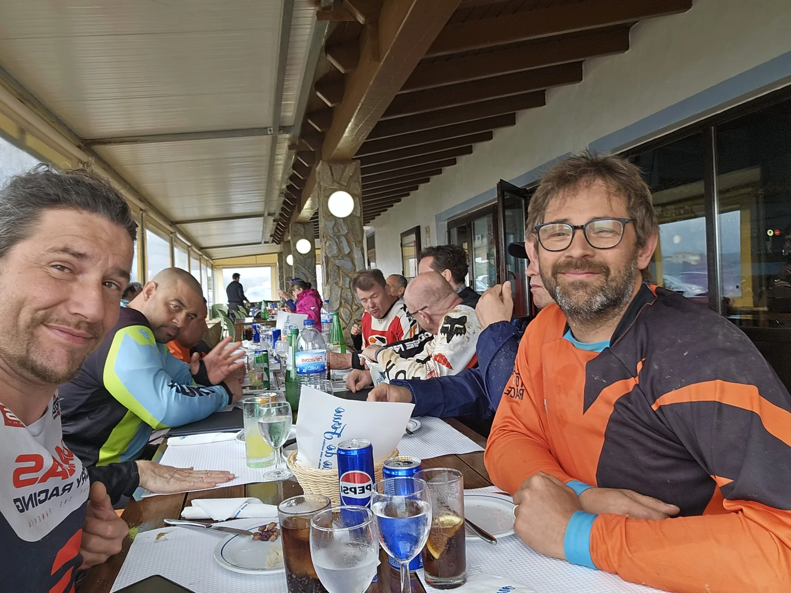 Riders sharing a meal at Sítio do Forno on the Carrapateira coast.