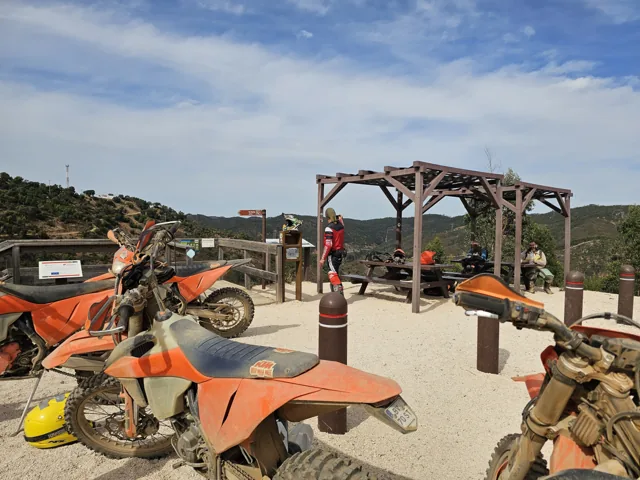 KTM motorcycles at a hillside viewpoint