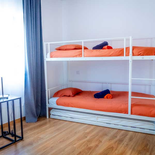 Shared guest room with bunk beds at the Let’s Ride Portugal house in Rasmalho