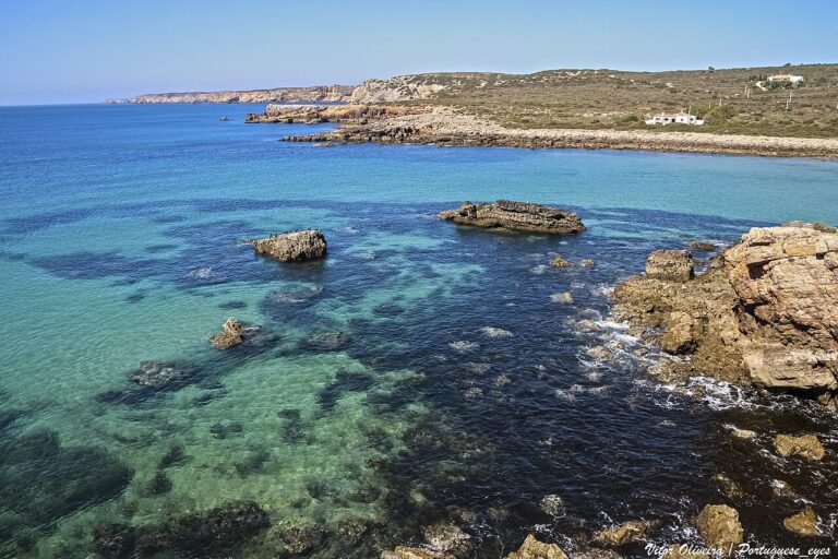 Praia da Ingrina, Algarve. Blue water around a small rocky bay.