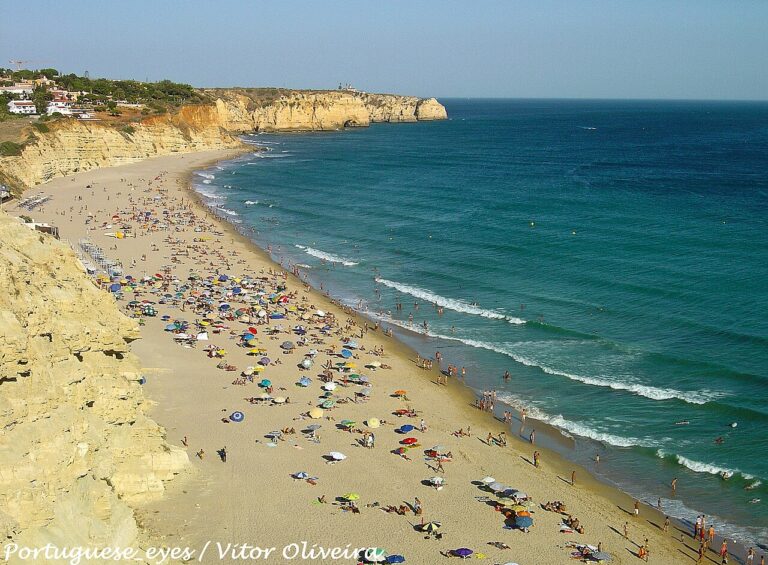 Praia de Porto de Mós, Algarve. A long curve of sand below the cliffs.