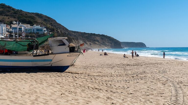 Praia da Salema, Algarve. Fishing boats and village beach life.