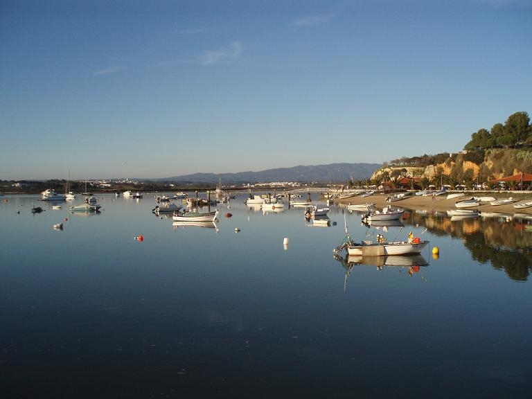 Fishing boats on the calm waters of the Alvor estuary.