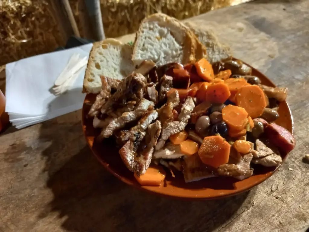A plate of grilled meat, vegetables and bread