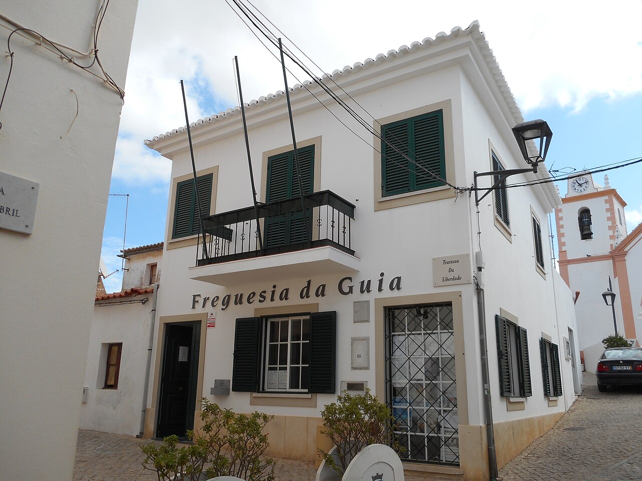 The white parish council building on a village street in Guia.