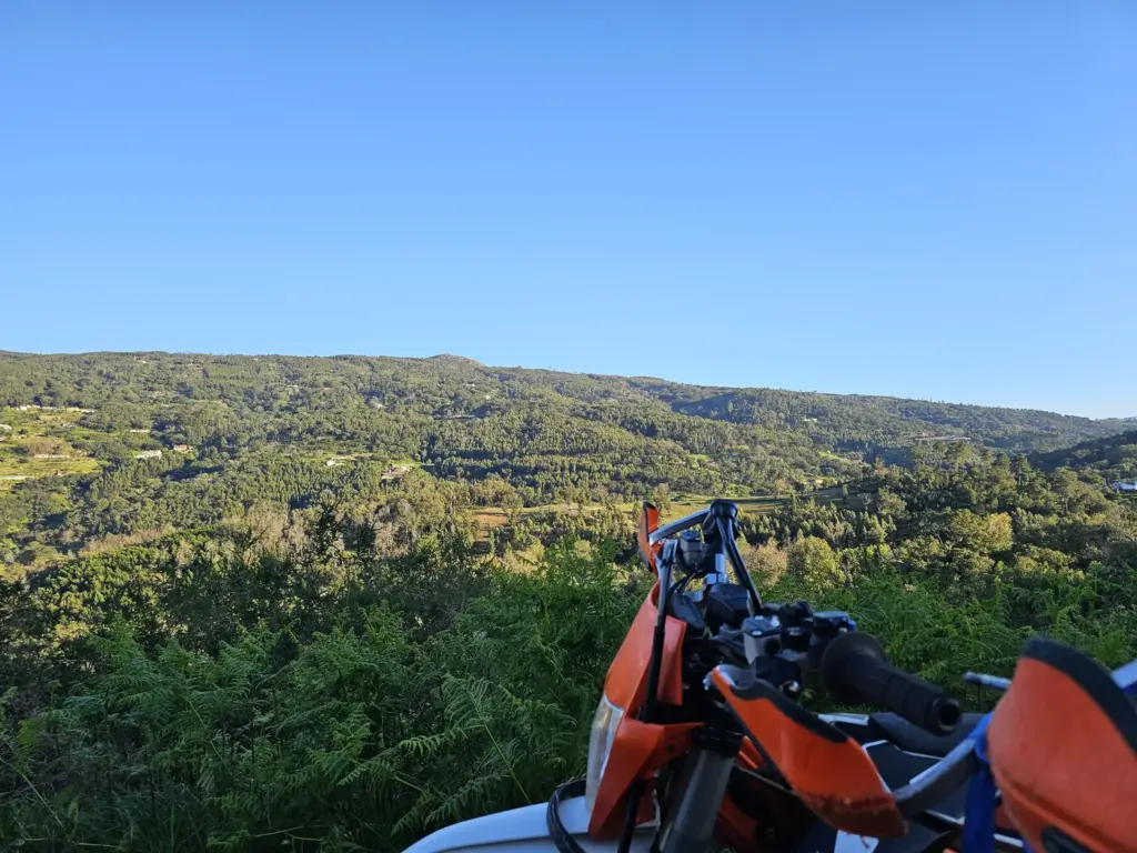 KTM enduro bike beside a wooded trail in the Monchique hills
