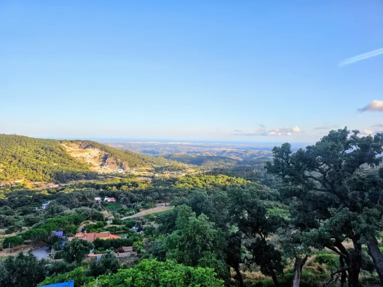 Wooded hills and distant coastline seen from a terrace near Monchique.