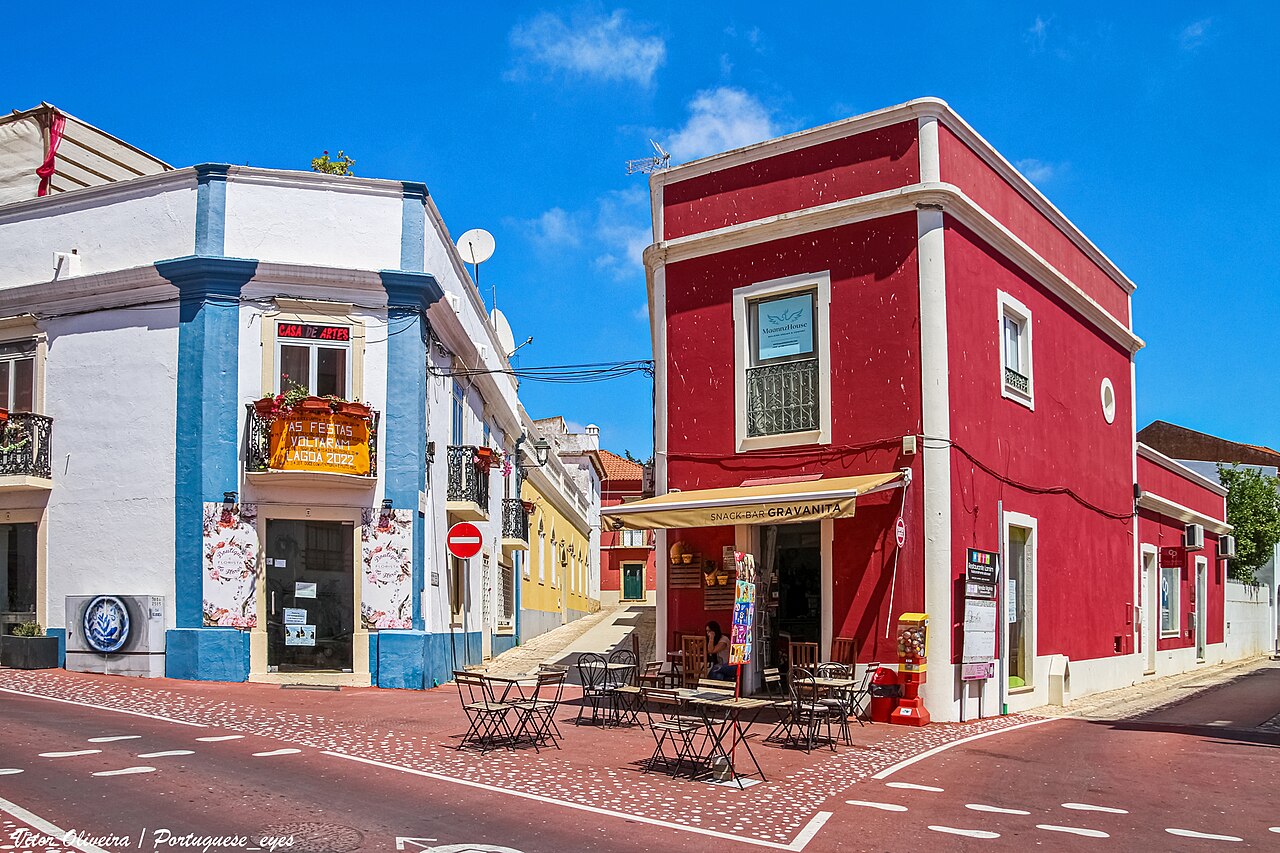 White and red façades at a street corner in Lagoa town.