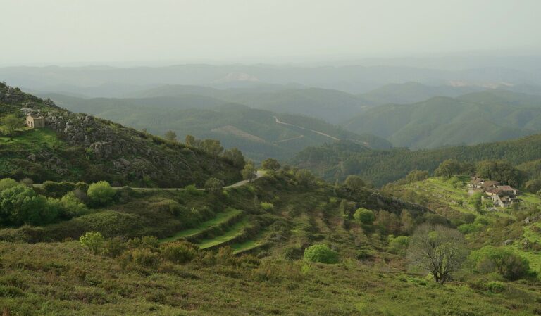 Green mountain ridges and a rural road near Barbelote in the Monchique mountains