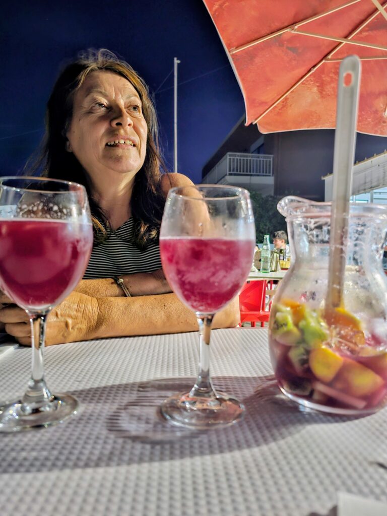 A guest and drinks on the terrace at O Castelo in the evening.