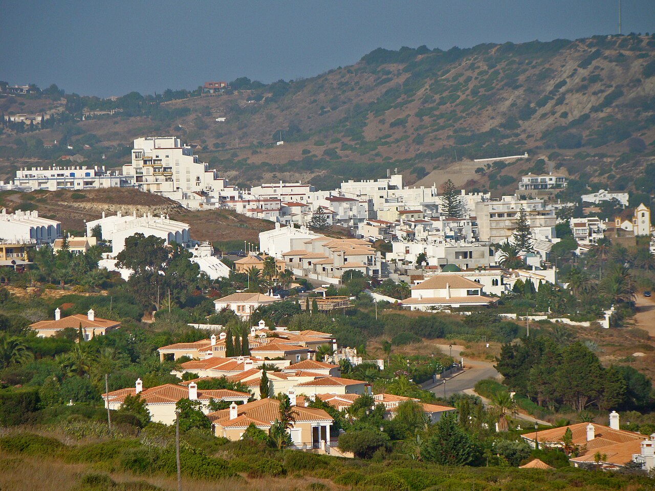 White buildings of Praia da Luz below the surrounding hills.