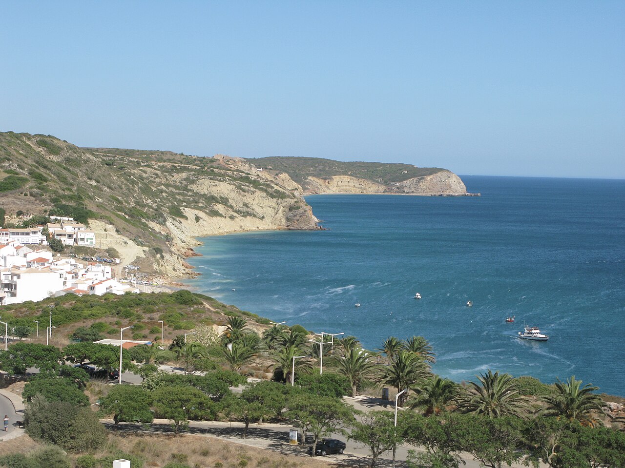 Salema village and its sandy bay between the western Algarve cliffs.